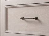 Close-up of the Venzone 64-Inch Cerused Oak 6-Drawer Dresser: the dark bronze bar pull on a moulded cerused oak drawer front