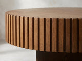 Close-up of the Vernazza Wood Veneer Fluted Pedestal Coffee Table: the ring of fluted slats under the notched rim of the top