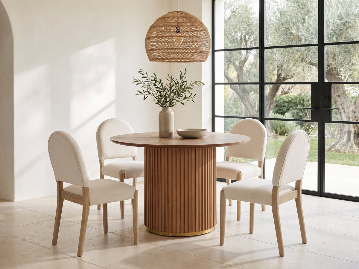 Veroli 47-Inch Round Fluted Pedestal Dining Set with 4 Chairs in a sunlit villa dining area with olive trees outside