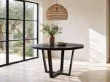 Verzino 47-Inch Round Black Acacia Sunburst Dining Table in a sunlit villa dining area with olive trees outside