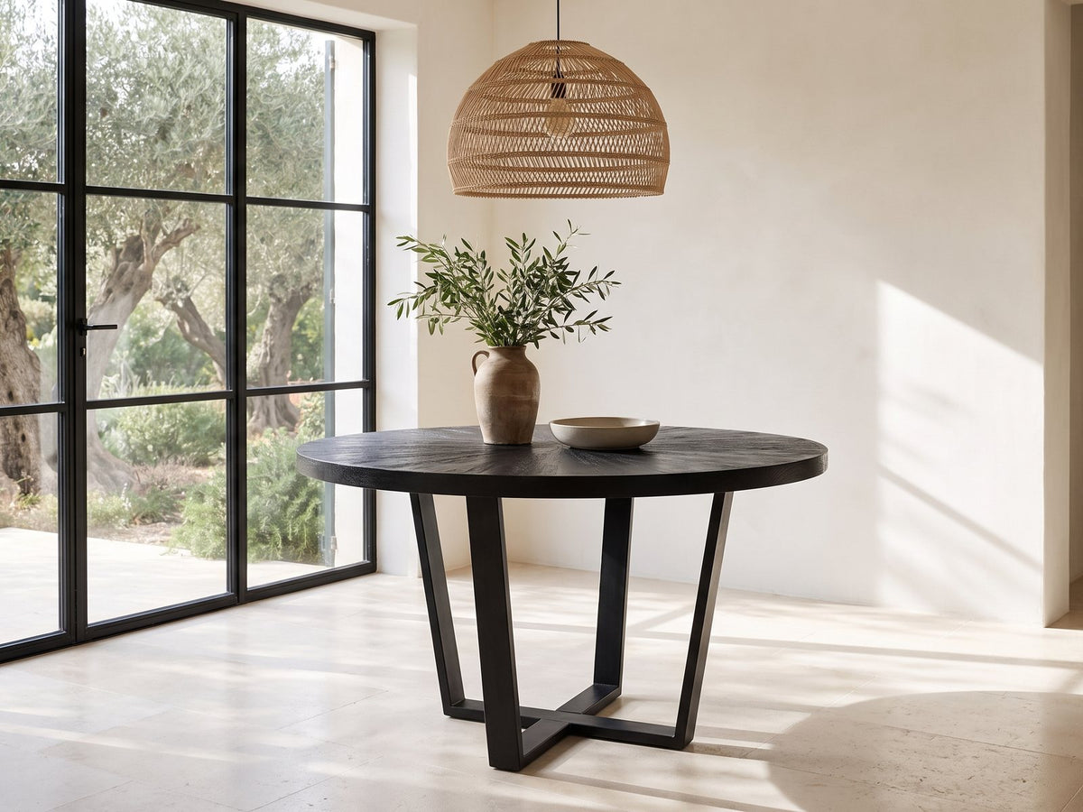 Verzino 47-Inch Round Black Acacia Sunburst Dining Table in a sunlit villa dining area with olive trees outside