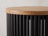 Close-up of the Viggiano Mango and Black Metal Drum Side Table: the mango top edge over the round black metal tubes