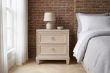 Villacidro washed oak nightstand with a lamp against an exposed brick wall in a Brooklyn bedroom with a herringbone floor