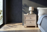 Villacidro washed oak nightstand with a ceramic lamp and bowl beside a bed in a Denver bedroom with a charcoal limewash wall
