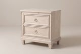 The Villacidro two-drawer nightstand in pale washed oak veneer, three-quarter view on a light studio backdrop