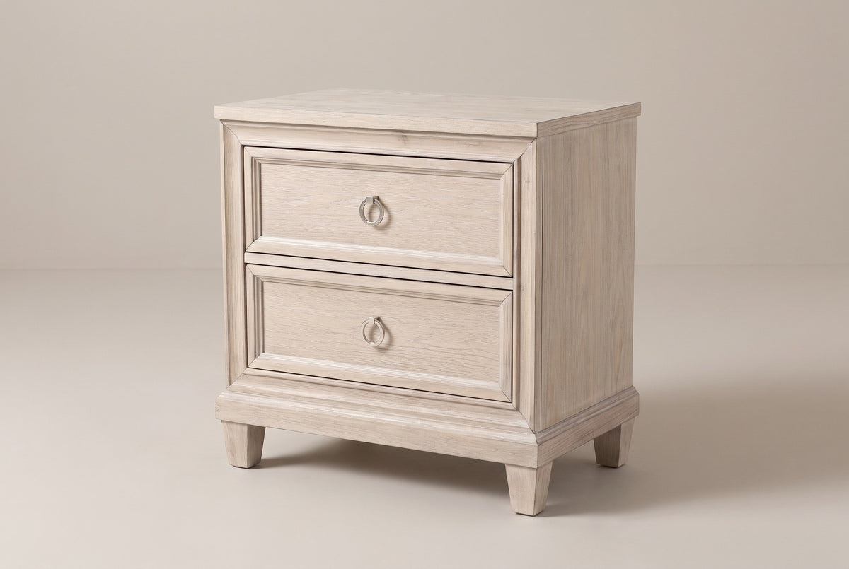 The Villacidro two-drawer nightstand in pale washed oak veneer, three-quarter view on a light studio backdrop