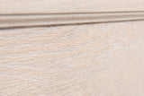 Close-up of the pale washed oak on the Villacidro nightstand: open pores showing as fine white lines beside a stepped moulding