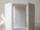 Close-up of the Vitozza White Marble Hexagon Side Table: an open face framed by the honed marble slabs