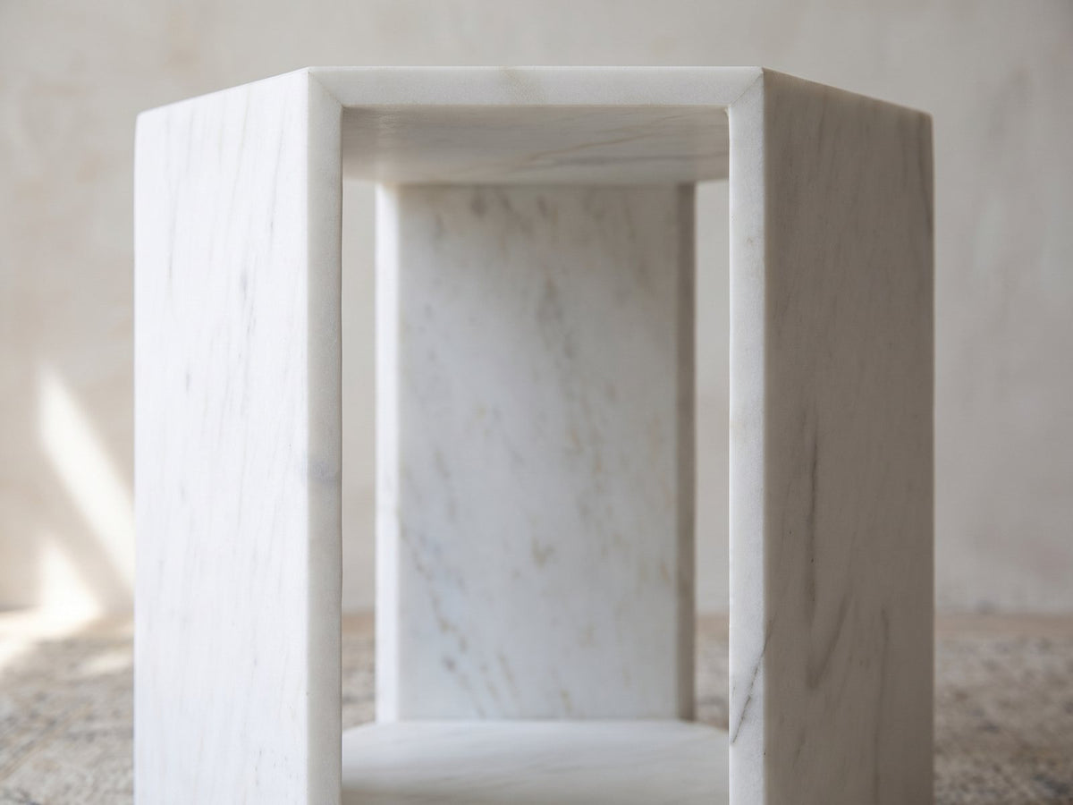 Close-up of the Vitozza White Marble Hexagon Side Table: an open face framed by the honed marble slabs