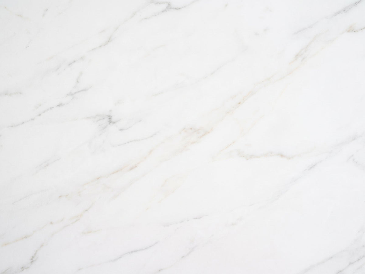 Close-up of the Vitozza White Marble Hexagon Side Table: the soft grey veining of the honed white marble top