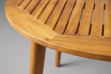 Close-up of the solid acacia on the Vittoria table: a border seam, the slat ends and a tapered leg in teak finish