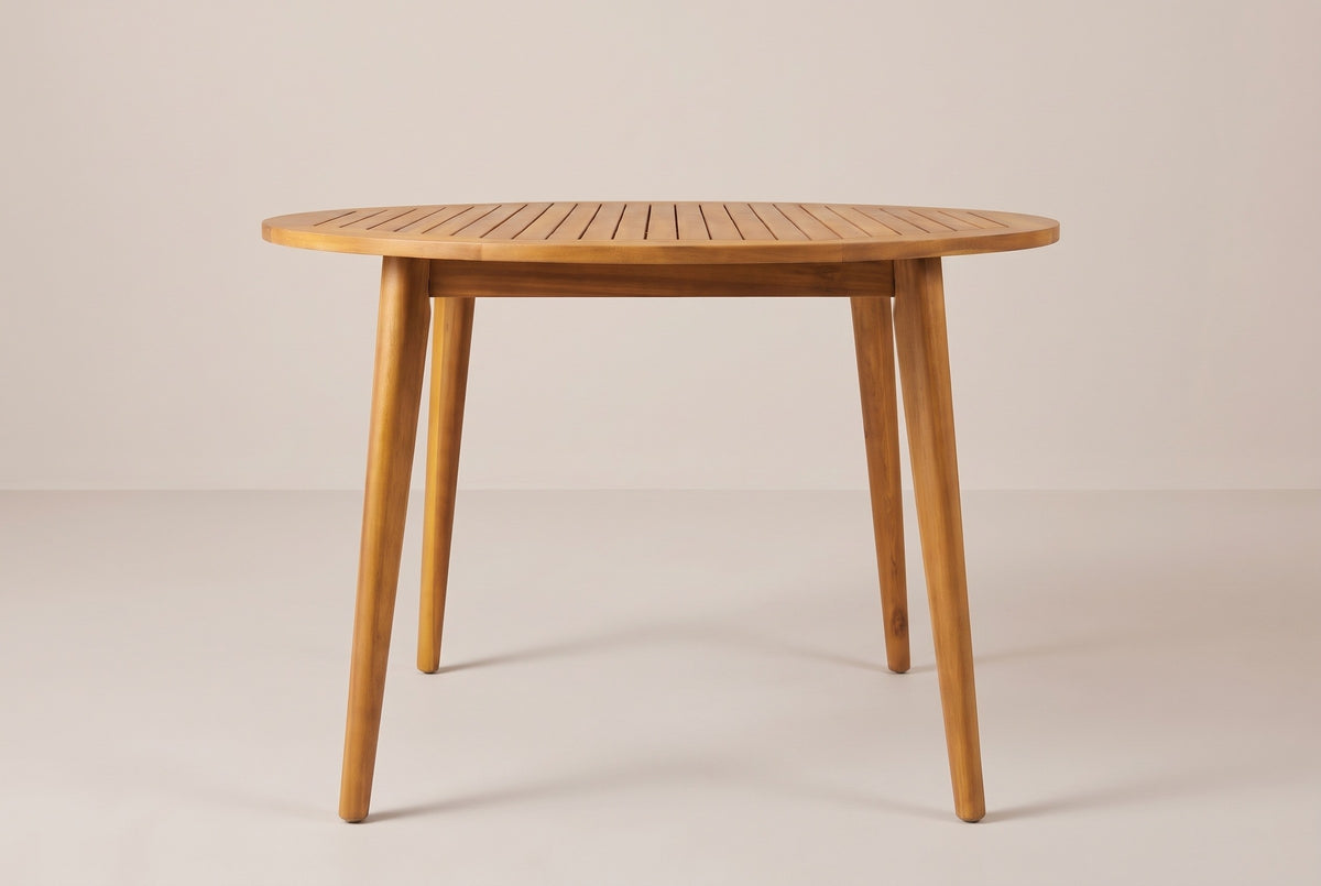 The Vittoria round dining table seen straight from the front: the thin slatted top on four splayed tapered legs