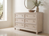 Vittorio 62-Inch Washed Oak 6-Drawer Dresser under a round bronze mirror in a villa bedroom