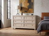 Vittorio 62-Inch Washed Oak 6-Drawer Dresser against a plaster wall in an industrial loft bedroom