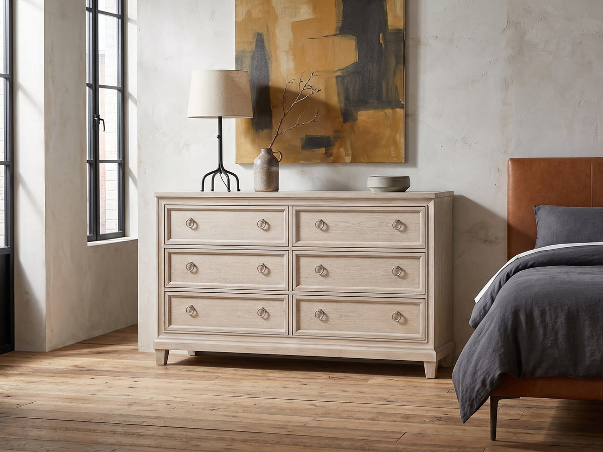 Vittorio 62-Inch Washed Oak 6-Drawer Dresser against a plaster wall in an industrial loft bedroom