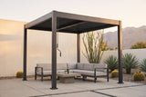 Zingaro black louvered pergola over a concrete patio in a Palm Springs desert garden with a white stucco wall, agave and the San Jacinto mountains (furniture not included)