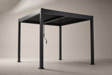 The Zingaro louvered pergola in matte black, three-quarter view on a light studio backdrop