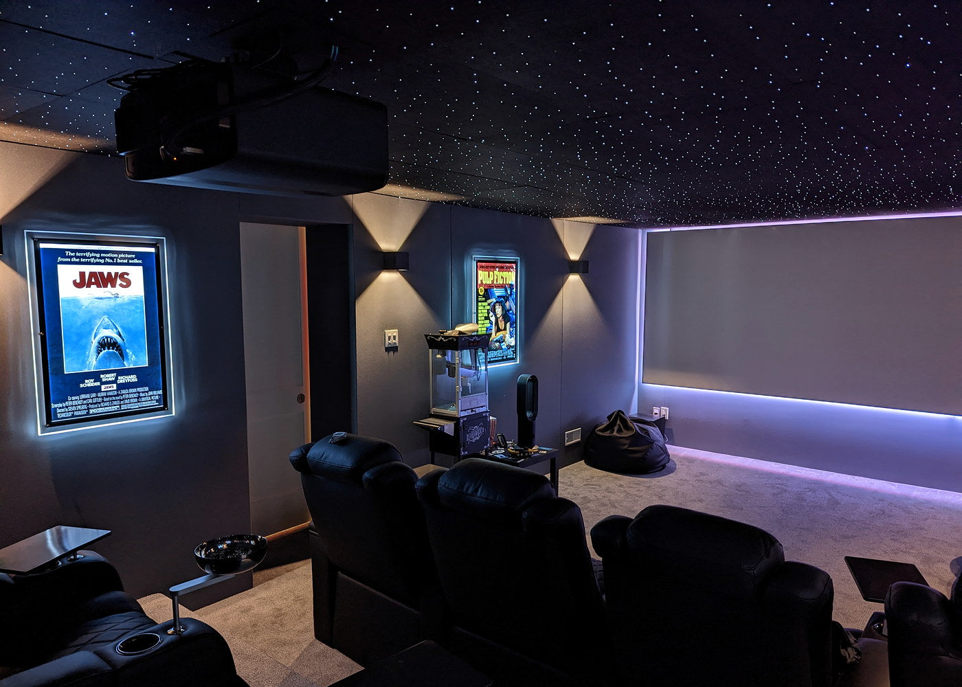 Immersive home theater with a star ceiling and projector